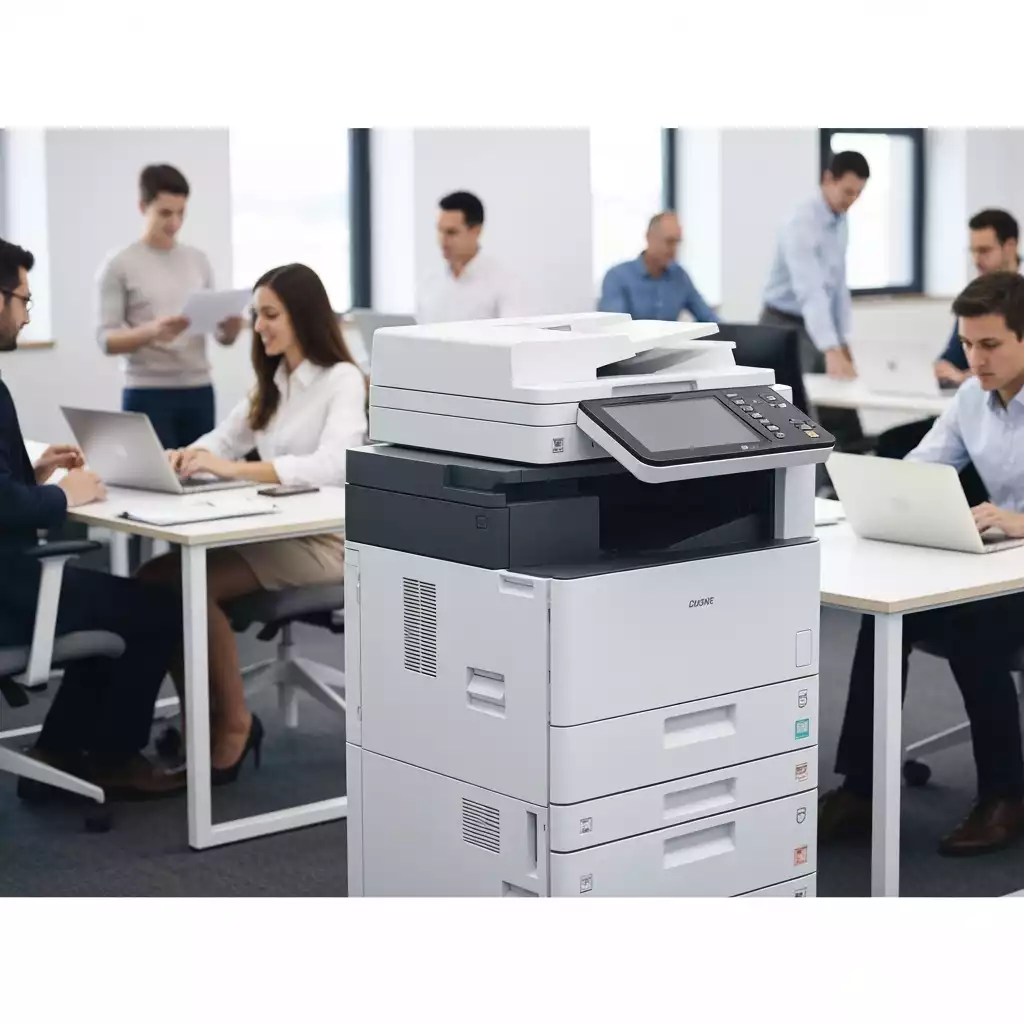 Modern commercial copier in a professional office setting with people working in the background